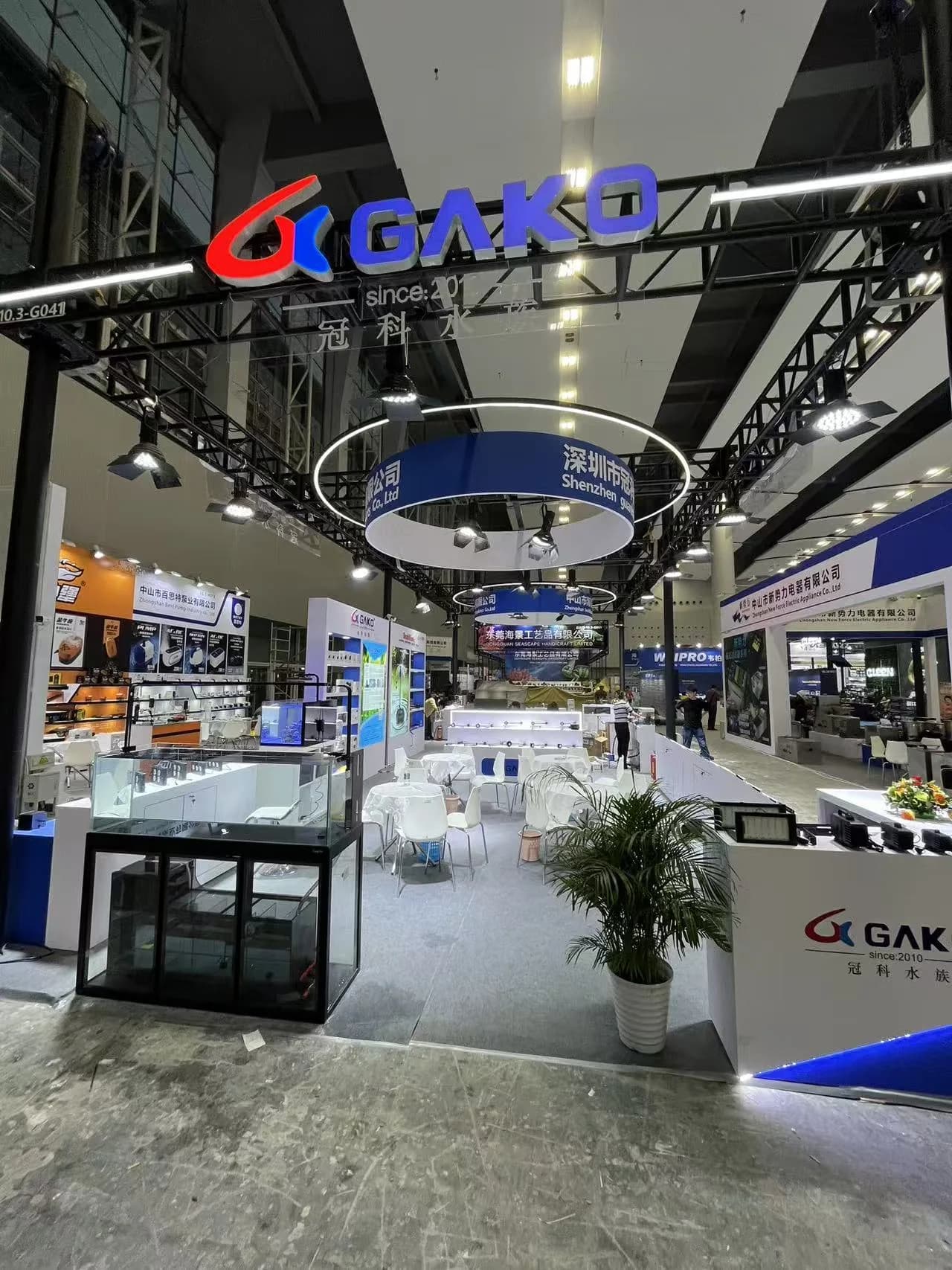 GAKO branded aquarium equipment booth with display tanks, product samples and meeting tables